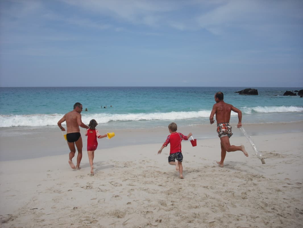 Family enjoying the white sand of Kua Bay